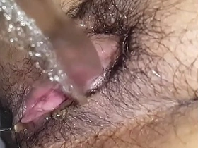 Hairy vagina babe pulling a piss closeup